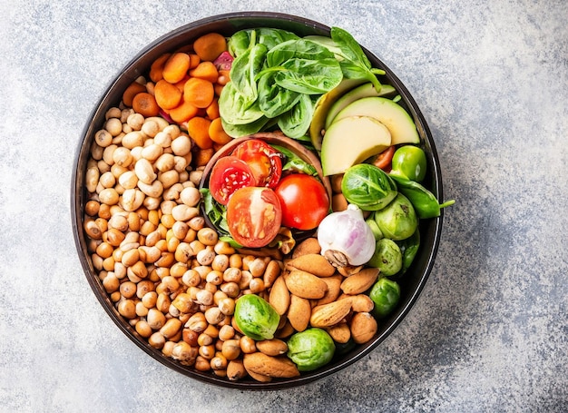 A bowl of salad with beans, avocado, and tomatoes