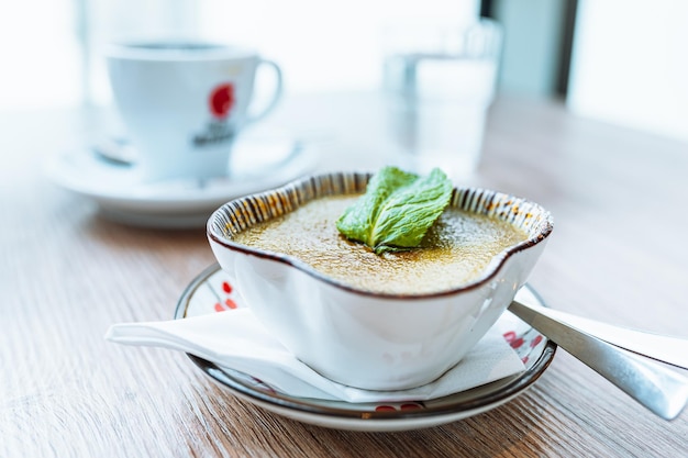 A bowl of soup with a red heart logo on the side