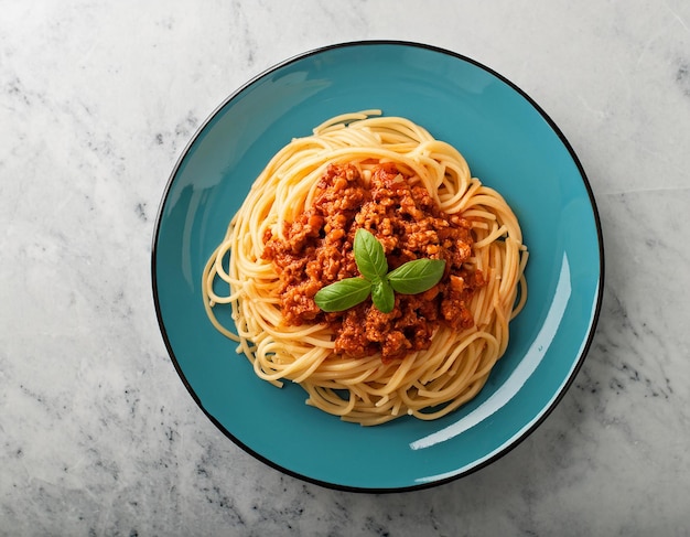 a bowl of spaghetti with a green leaf on top of it