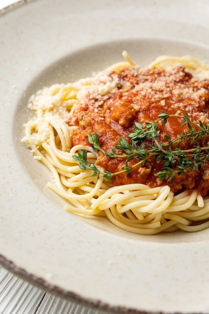 A bowl of spaghetti with meat sauce and parmesan cheese