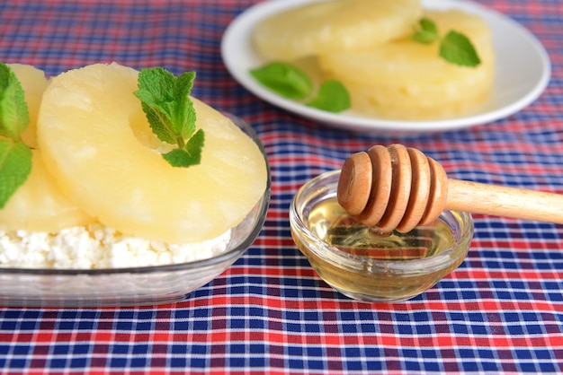 Bowl of tasty cottage cheese with pineapple close up