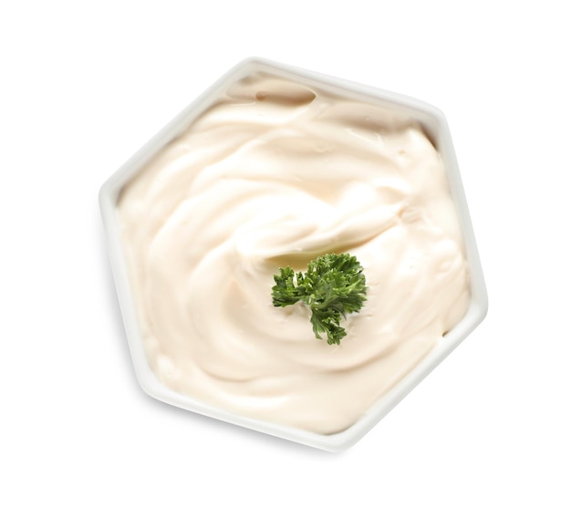 Bowl of tasty mayonnaise with parsley isolated on white top view