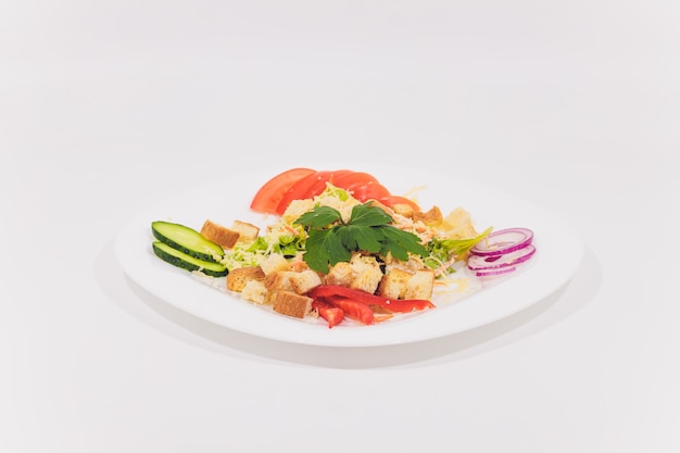 Bowl of Traditional Caesar Salad with Chicken and Bacon isolated