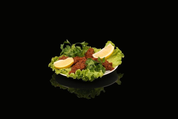 Bowl of Turkish salad with Bulgur, spices and minced meat with lemon