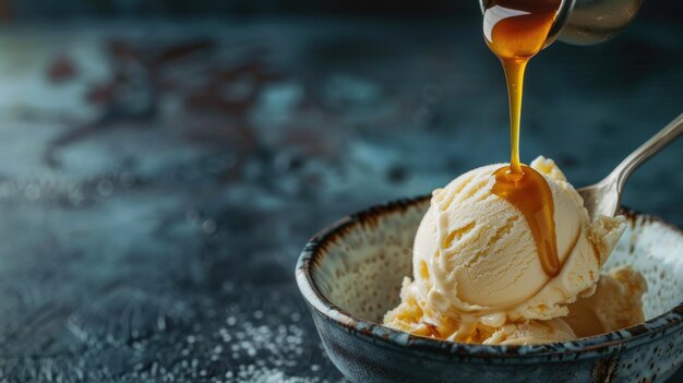 Photo bowl of vanilla ice cream with caramel syrup being poured on top