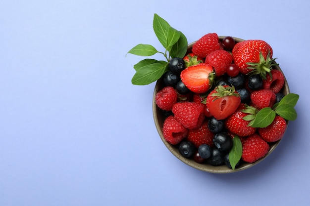 Bowl with berry mix on violet