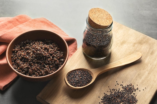 Bowl with boiled quinoa grains on kitchen table