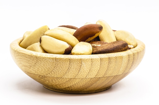 Bowl with brazilian chestnut, on white insulator background. Brazil nuts known as "Para Brazil nut".