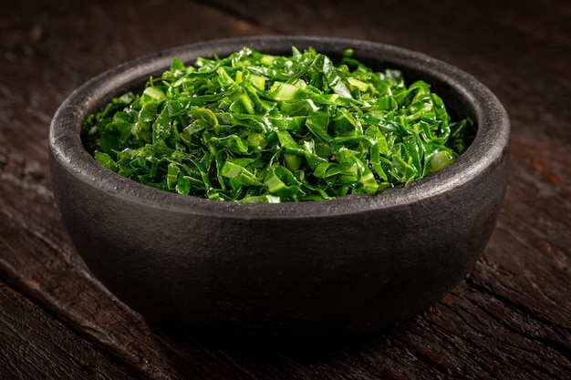 Bowl with chopped green cabbage sauteed in olive oil and garlic.