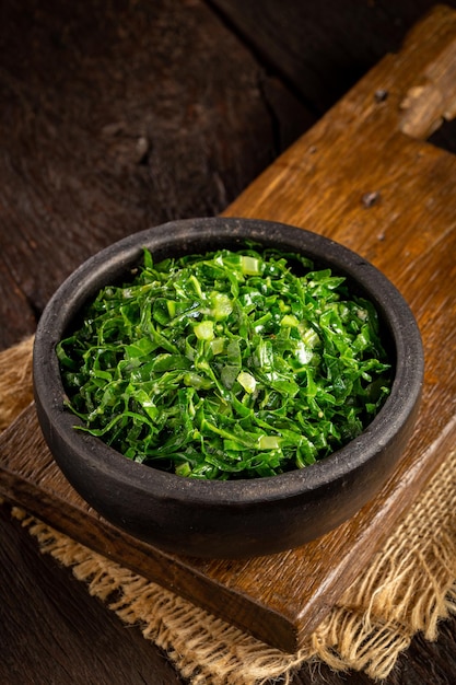 Bowl with chopped green cabbage sauteed in olive oil and garlic.