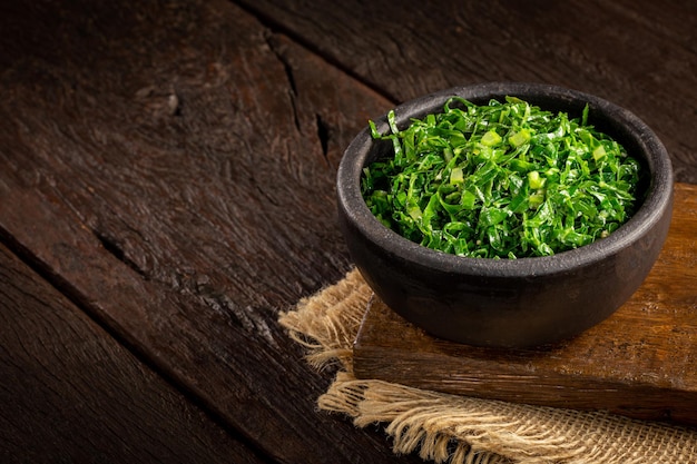 Bowl with chopped green cabbage sauteed in olive oil and garlic.