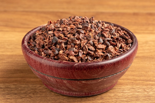 Bowl with cocoa nibs on the table