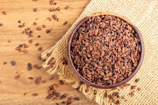 Bowl with cocoa nibs on the table