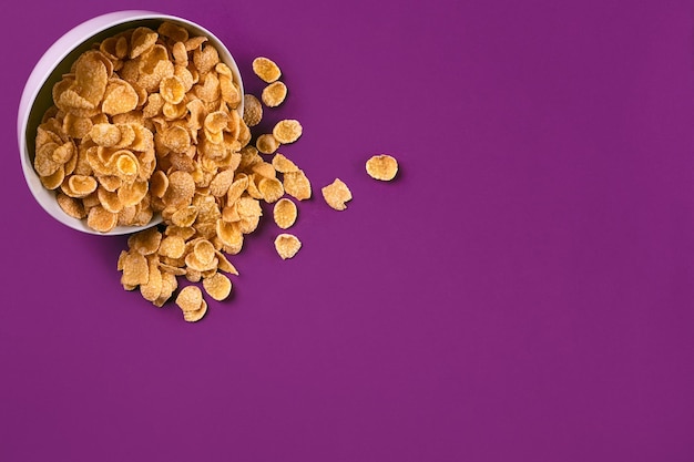 Bowl with cornflakes on the colorful background