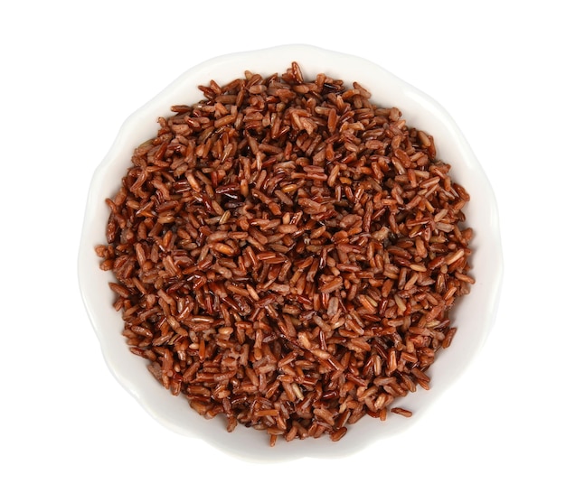 Bowl with delicious cooked brown rice on white background top view