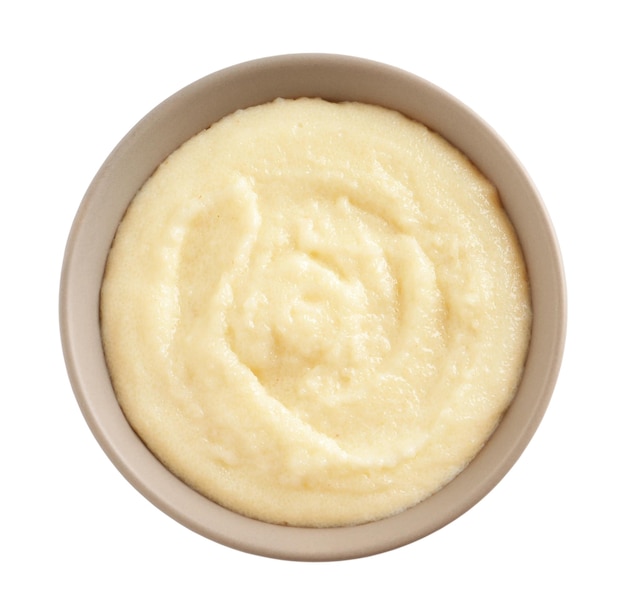 Bowl with delicious semolina pudding on white background top view