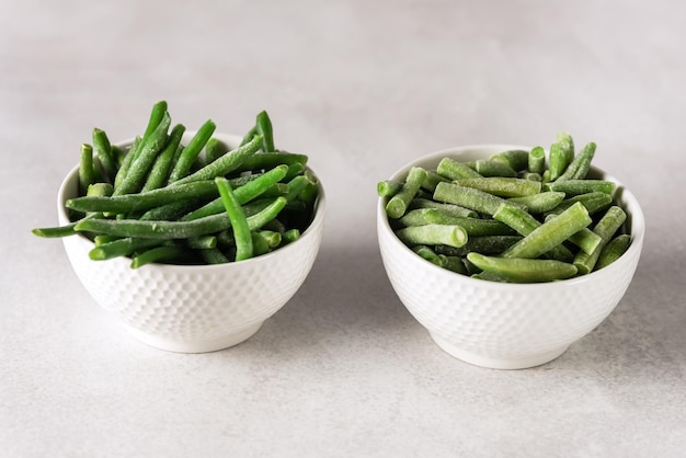 Photo bowl with frozen green beans on gray background diet vegan food horizontal