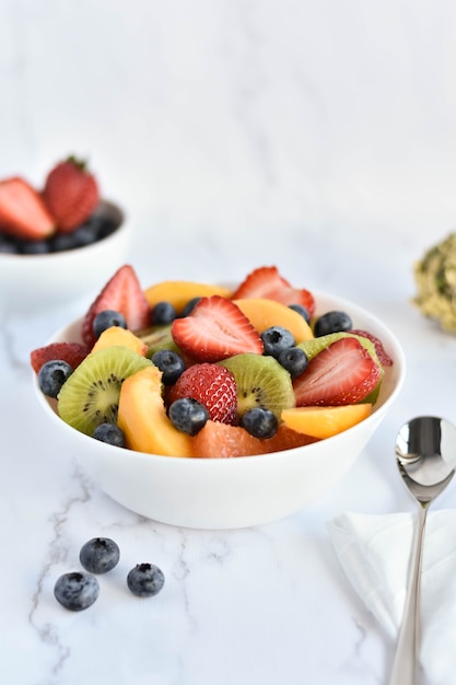 bowl with fruits salad on table