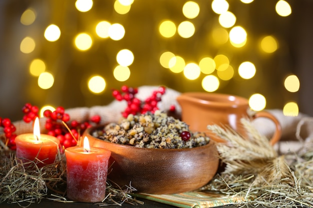 Bowl with kutia -  traditional Christmas sweet meal in Ukraine, Belarus and Poland, on wooden table, on bright background