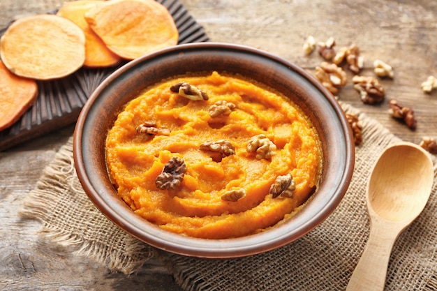 Bowl with mashed sweet potato on table