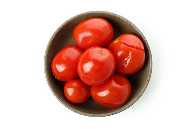 Bowl with pickled tomatoes isolated on white background