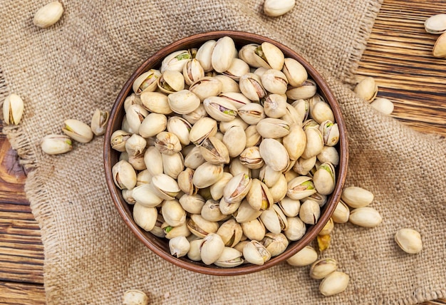 Bowl with pistachios on the table Top view