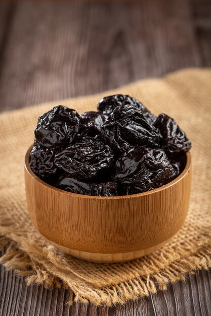 Bowl with prunes on the table