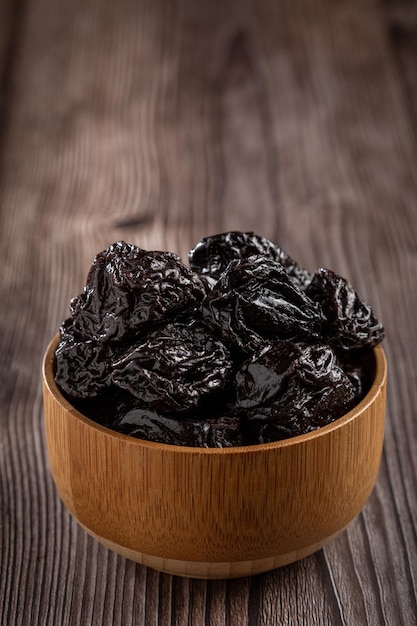 Bowl with prunes on the table