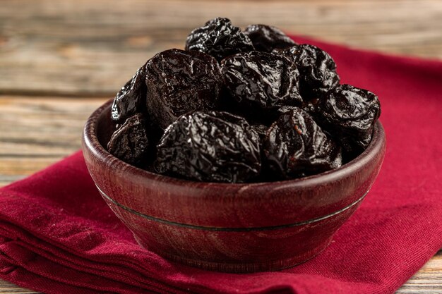 Bowl with prunes on the table