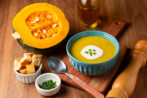 Bowl with pumpkin soup on the table.