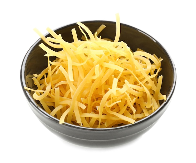 Bowl with raw pasta on white background