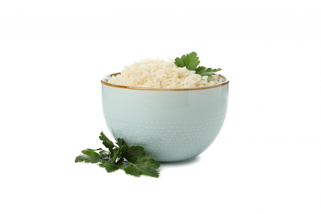 Bowl with rice and parsley isolated on white surface