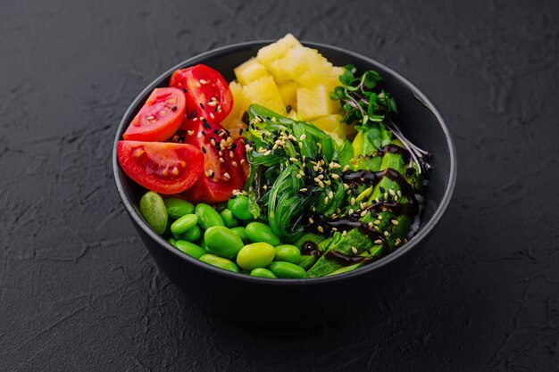 bowl with seaweed beans avocado and pineapple