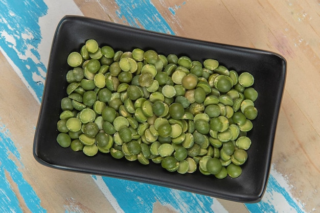 Bowl with soy beans on blue rustic wooden table