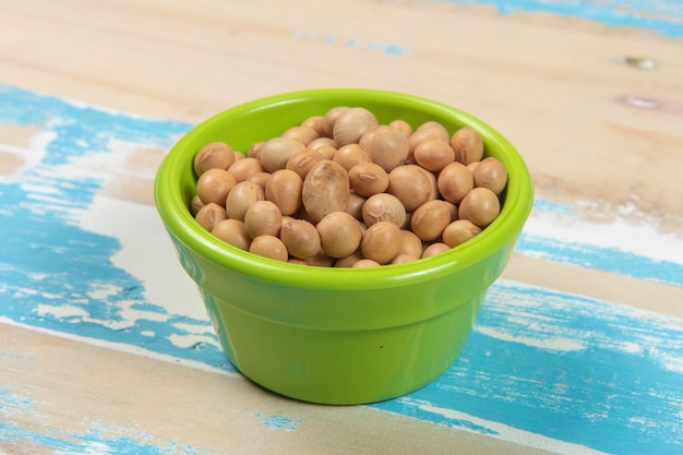 Bowl with soy beans on blue rustic wooden table