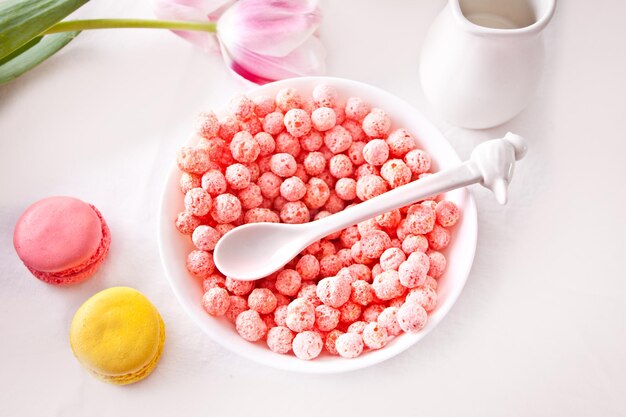 Bowl with strawberry sweet corn balls. Delicious and healthy breakfast cereal.