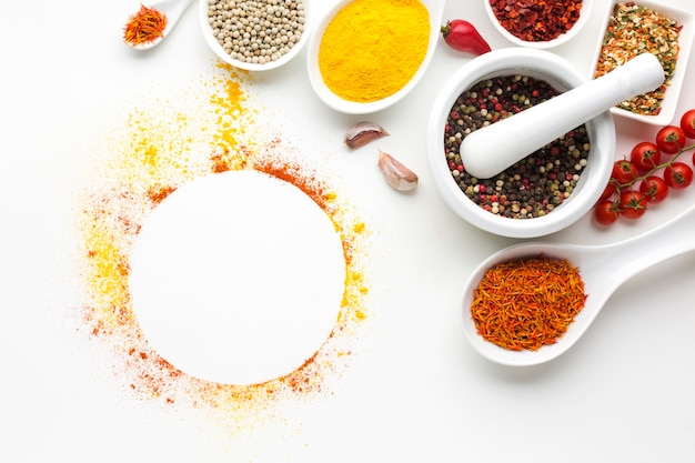 Bowls and spoons with spices on table 