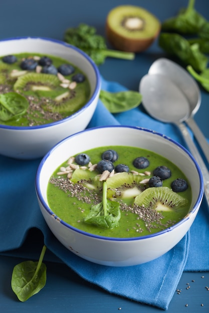 Bowls with smoothie from greens and blueberries