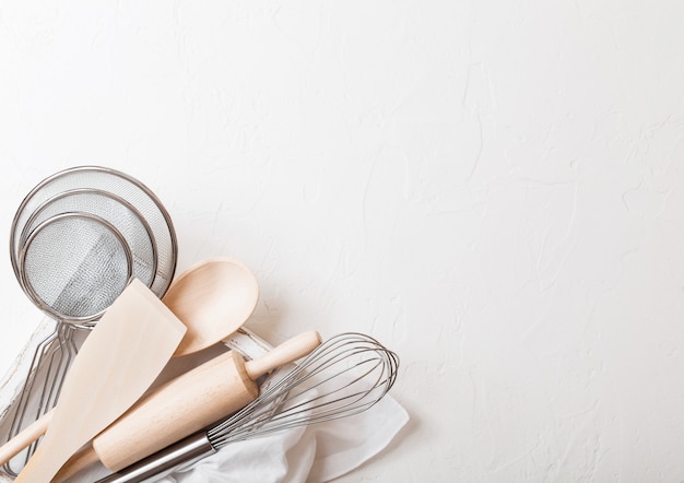 Box of baking utensils. Whisk, mesh and spatula in vintage wooden box.Top view.