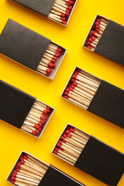 Box of matches on yellow background Vertical photo