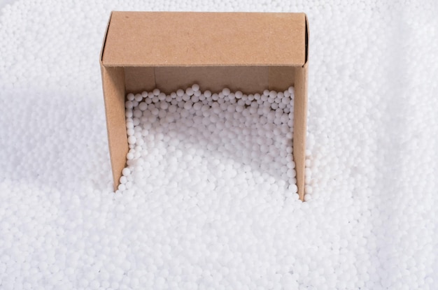 Box on white polystyrene foam balls