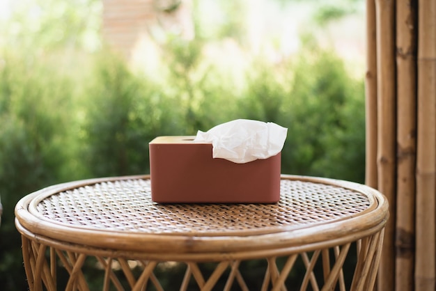 Box with paper tissues on table in cafe