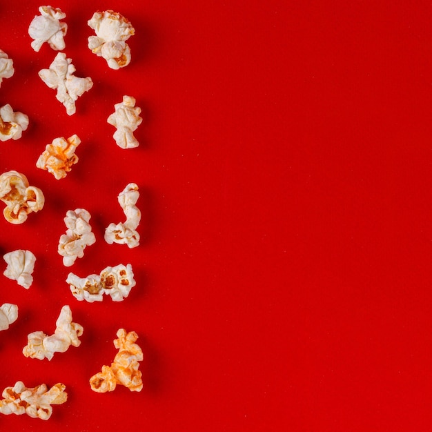 box with popcorn on a red background closeup