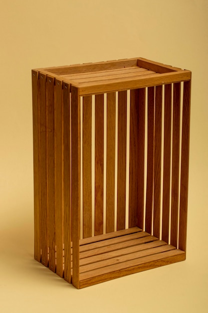 A box of wooden slats on a beige background closeup