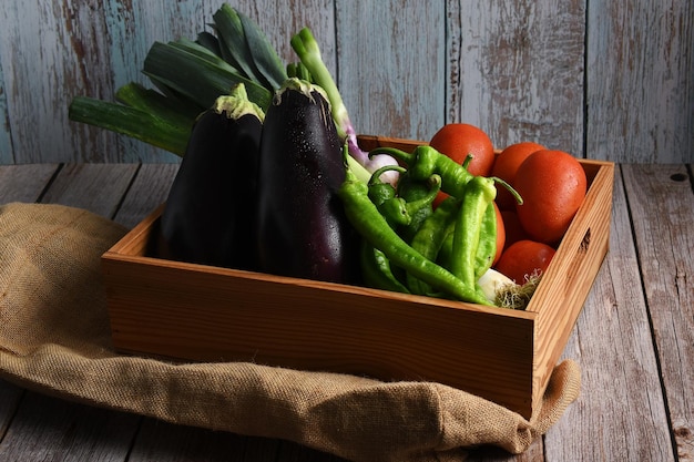 Box or wooden tray with organic vegetables from the garden