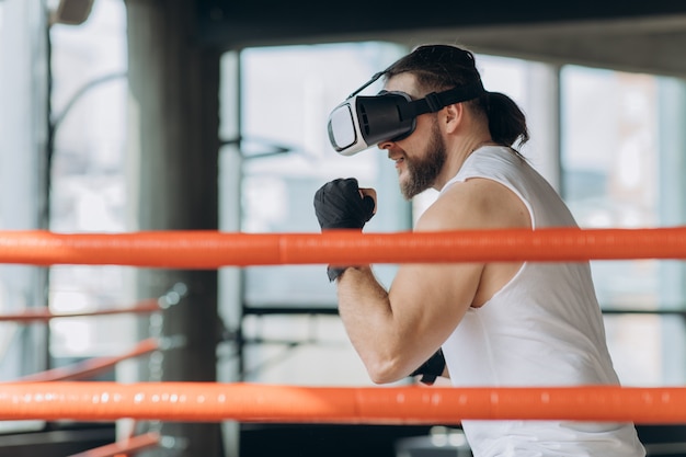 Boxer man with vr glasses fighting in simulated virtual reality