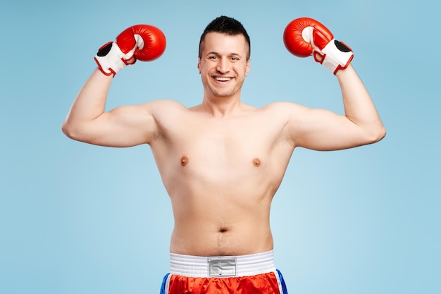 Boxer raising fists in victory after winning fight