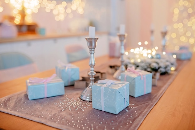 boxes with gifts on decorated christmas table