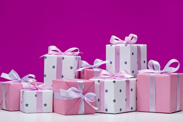 Boxes with gifts on pink