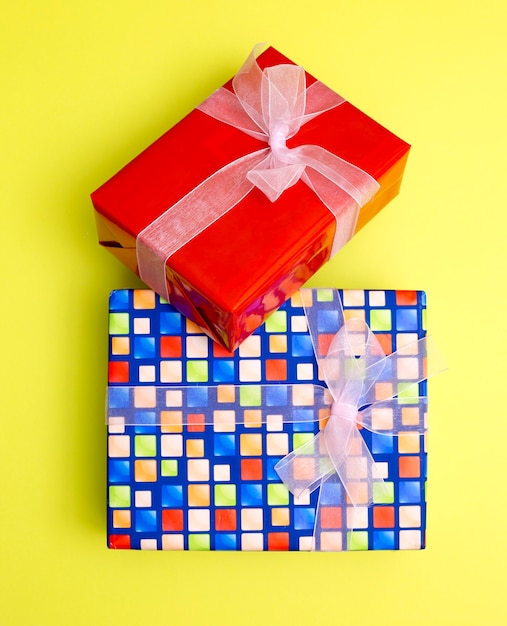 Boxes with gifts and surprises on a yellow